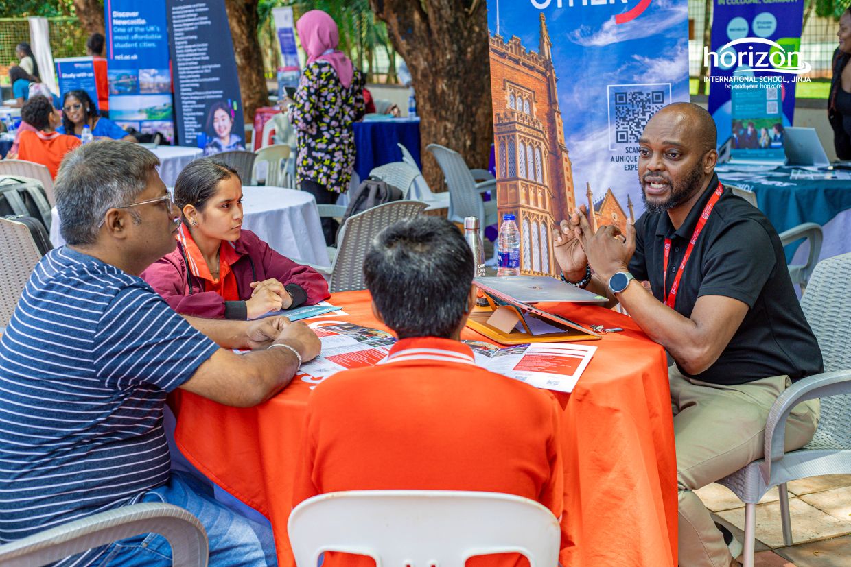 Parents and students in conversation with an international university representative